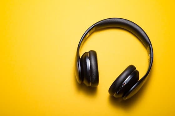 black headphones against yellow background.