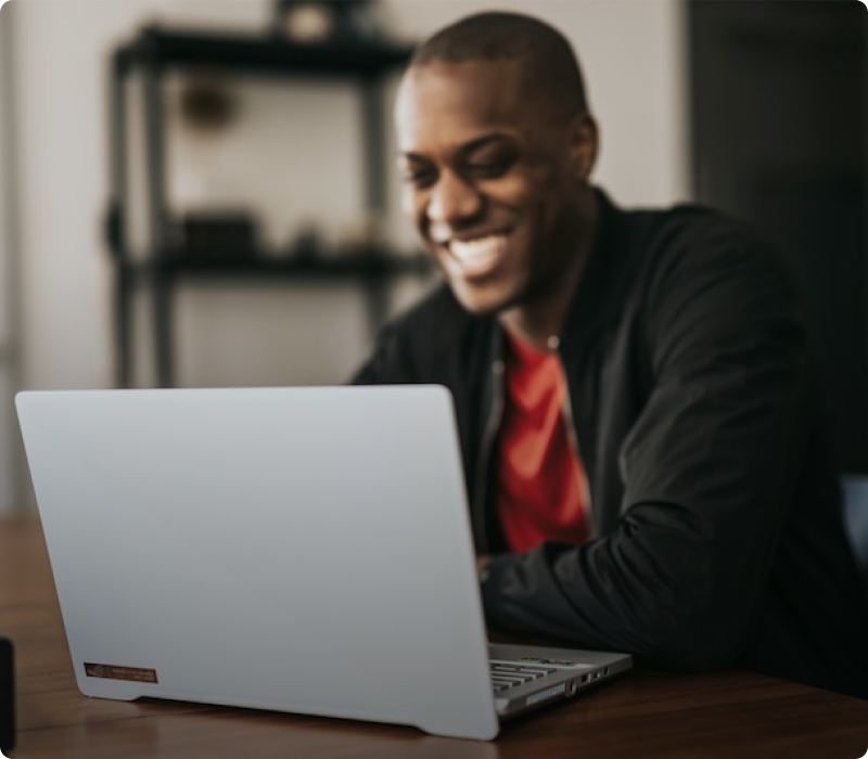 Man with smile looking at laptop