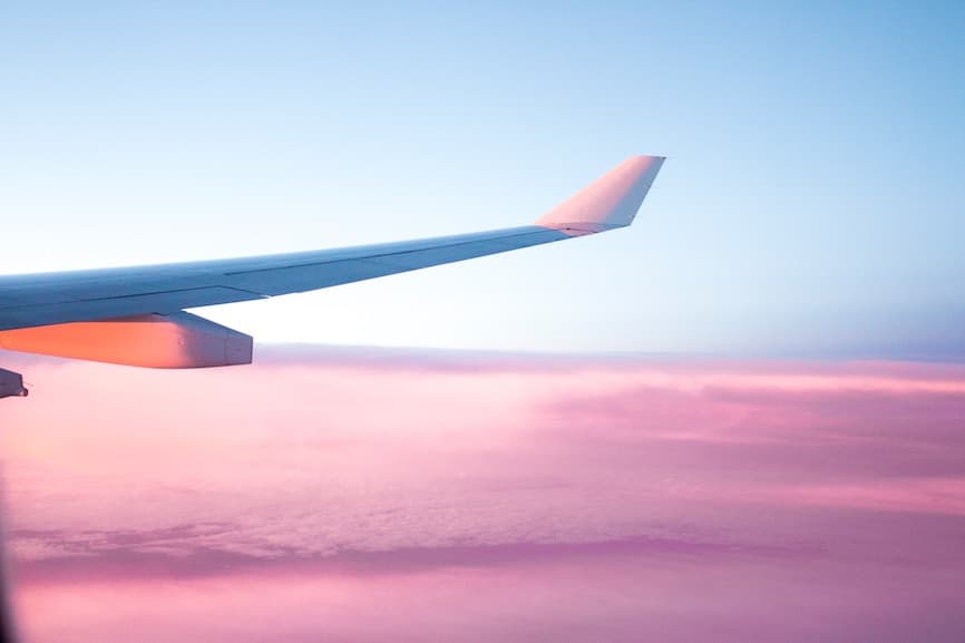 An airplane flying at sunset