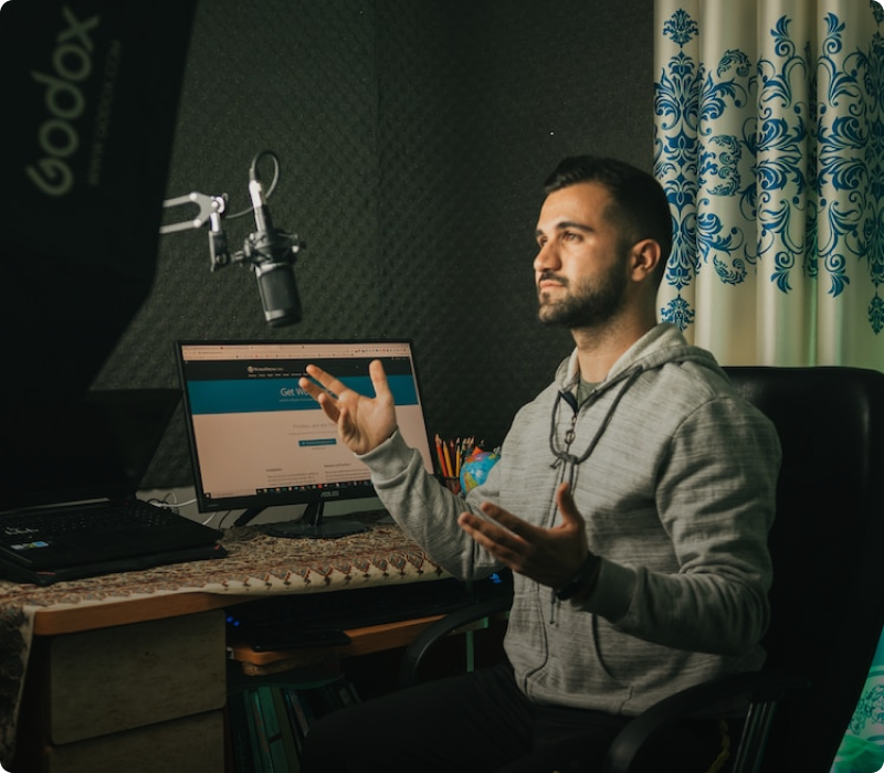 Man at desk filming